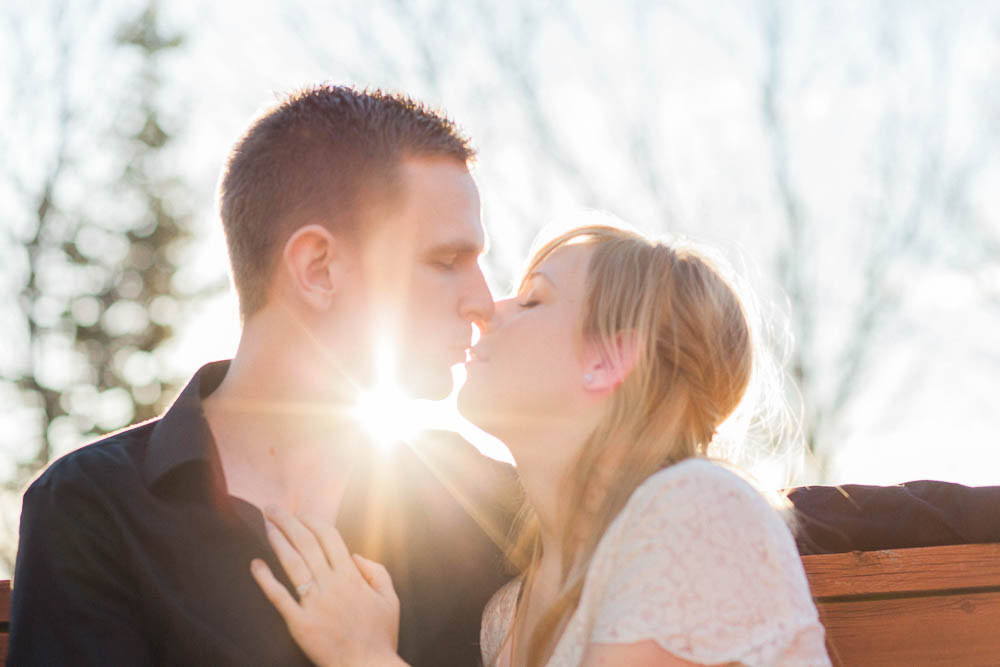 Couple kissing with sun behind their heads